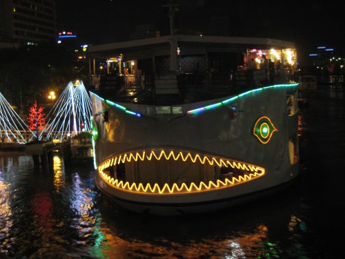 An illuminated restaurant boat on the Saigon River