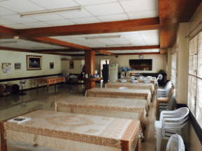 A view of the dining room with the kitchen in the distance