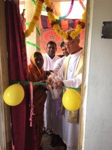 Br. Thambi's mother, Fr. Suresh, Fr. Michael Augustine and Fr. Tom cutting the ribbon for the new house. 